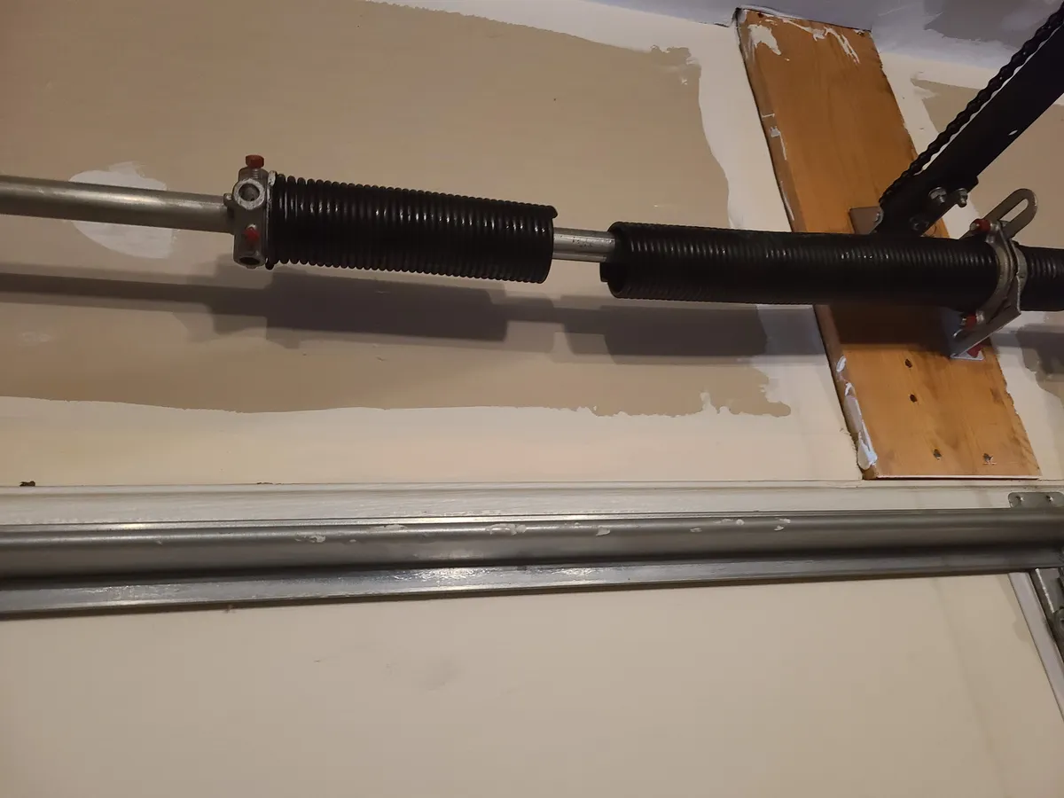 Garage door torsion springs and shaft during an iFix maintenance tune-up